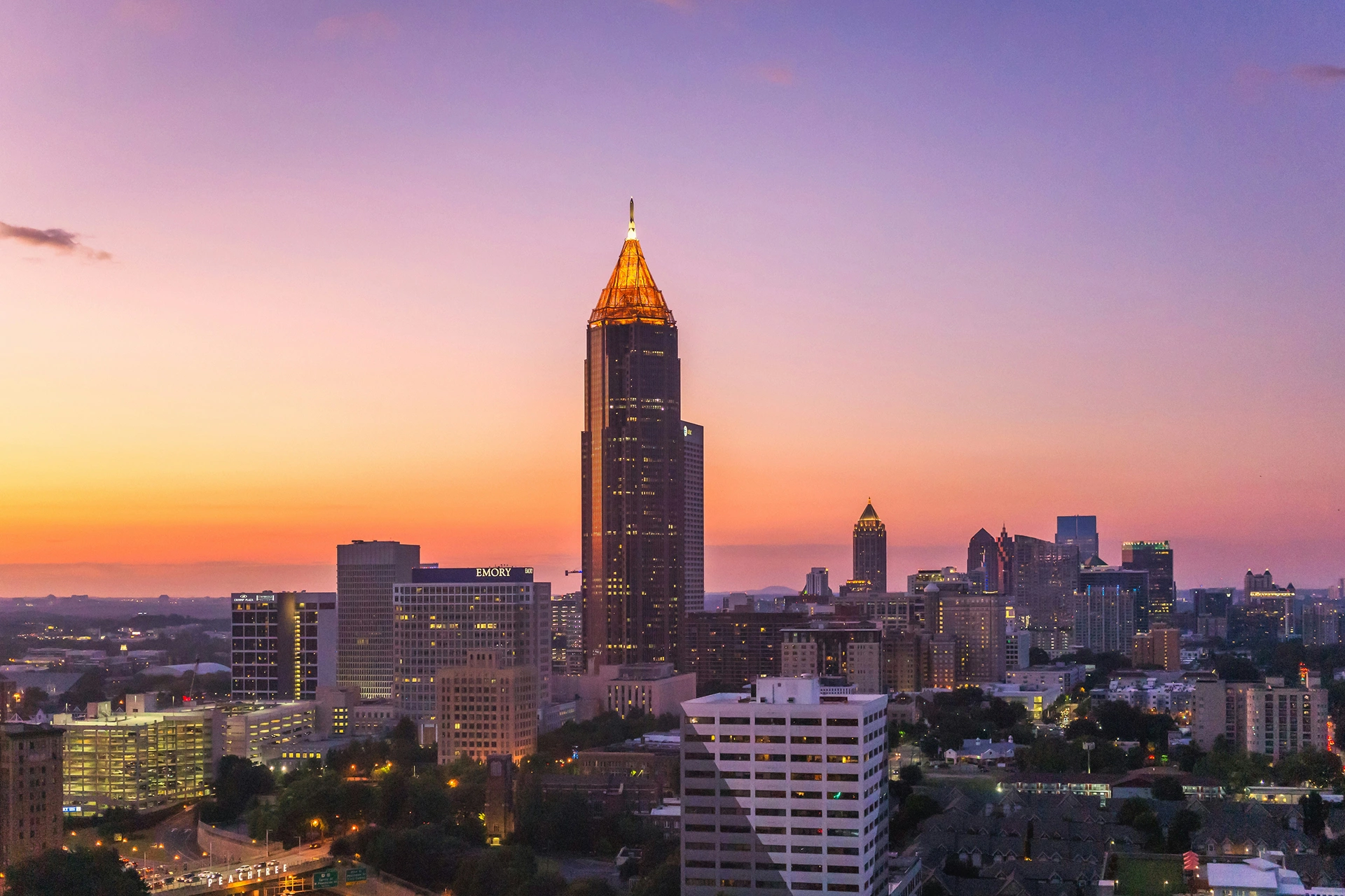 The illuminated Atlanta skyline at sunset with a colorful sky