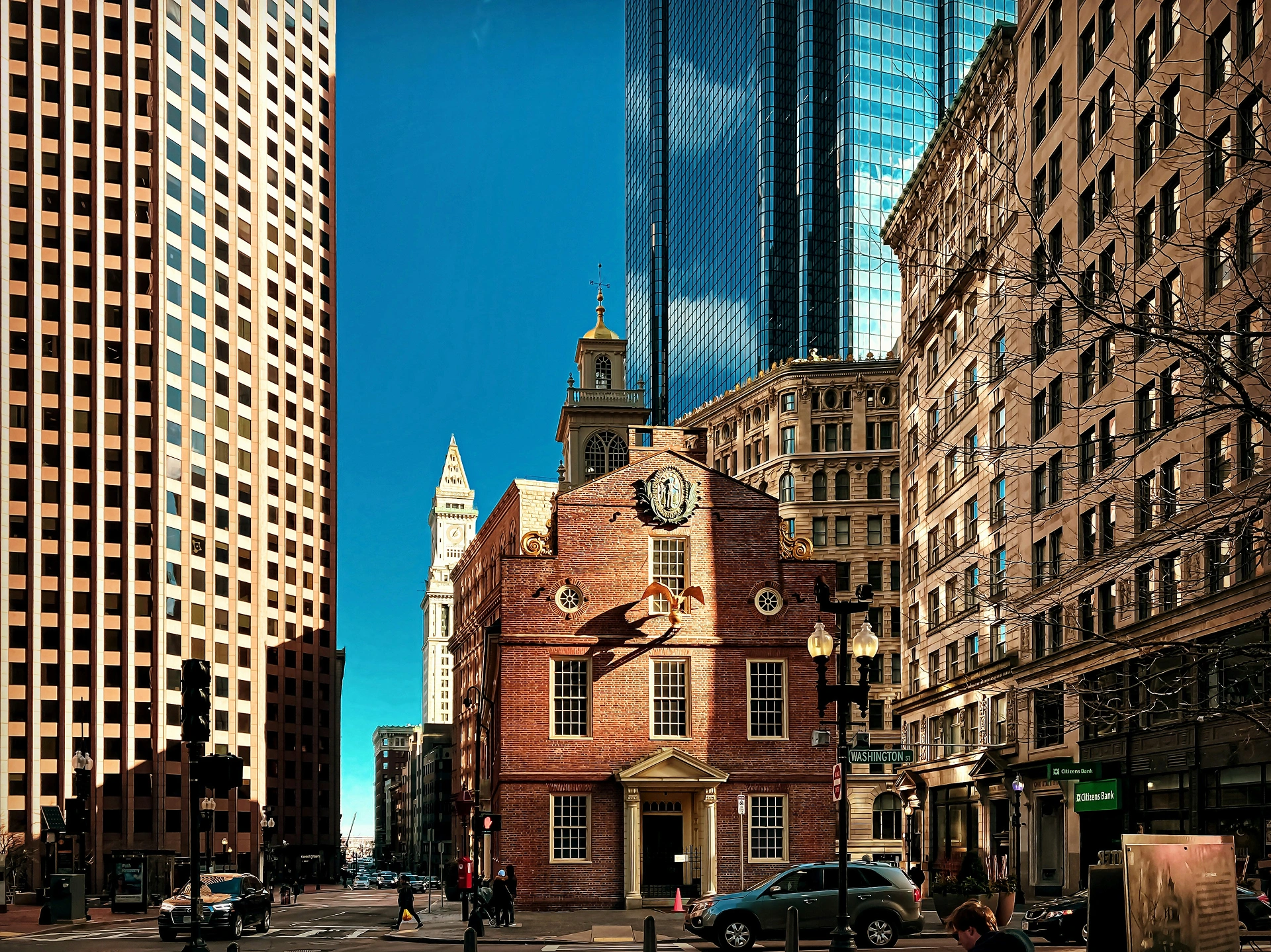 The Old State House in Boston surrounded by modern skyscrapers and city streets