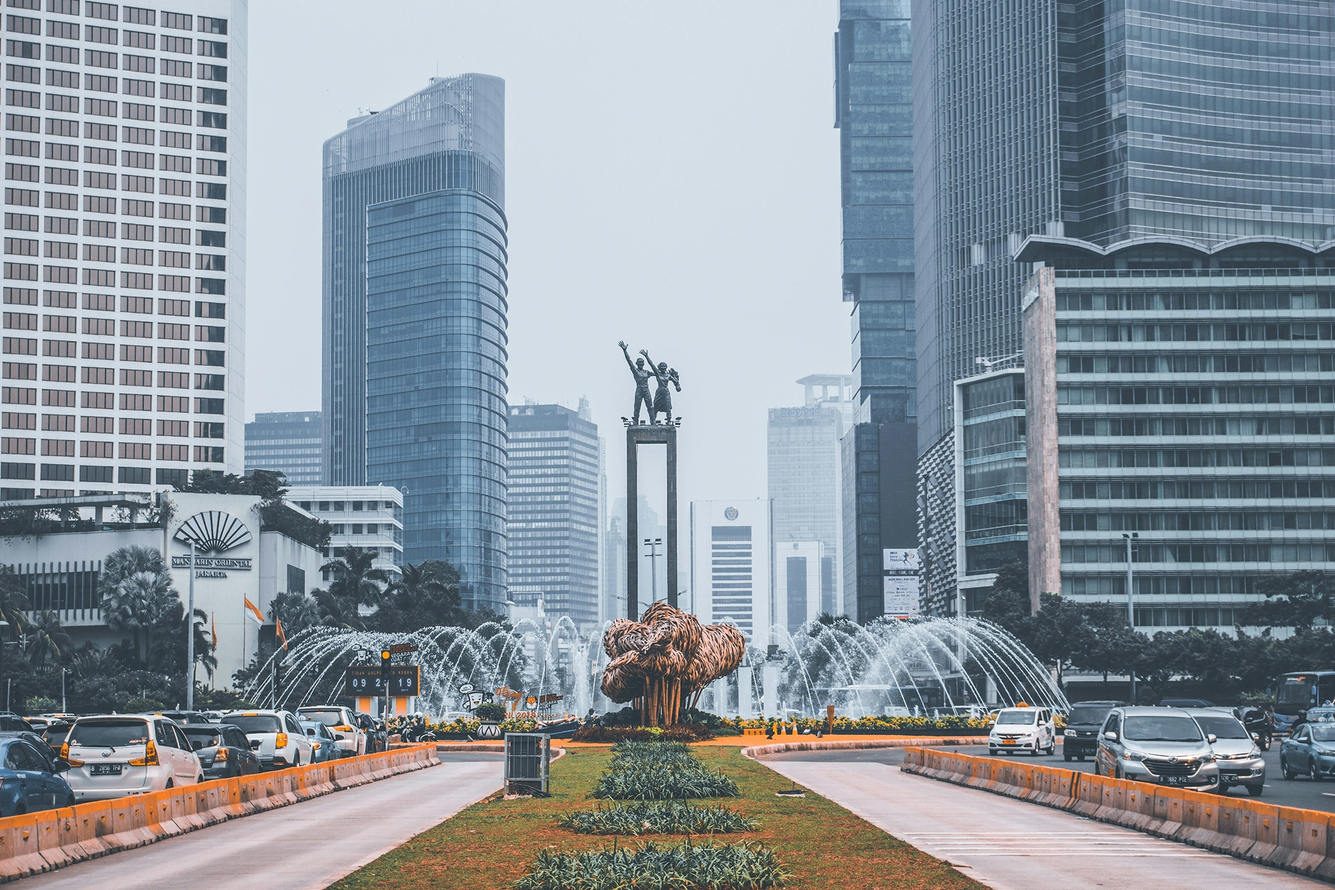 Jakarta's Selamat Datang Monument with surrounding skyscrapers and fountain