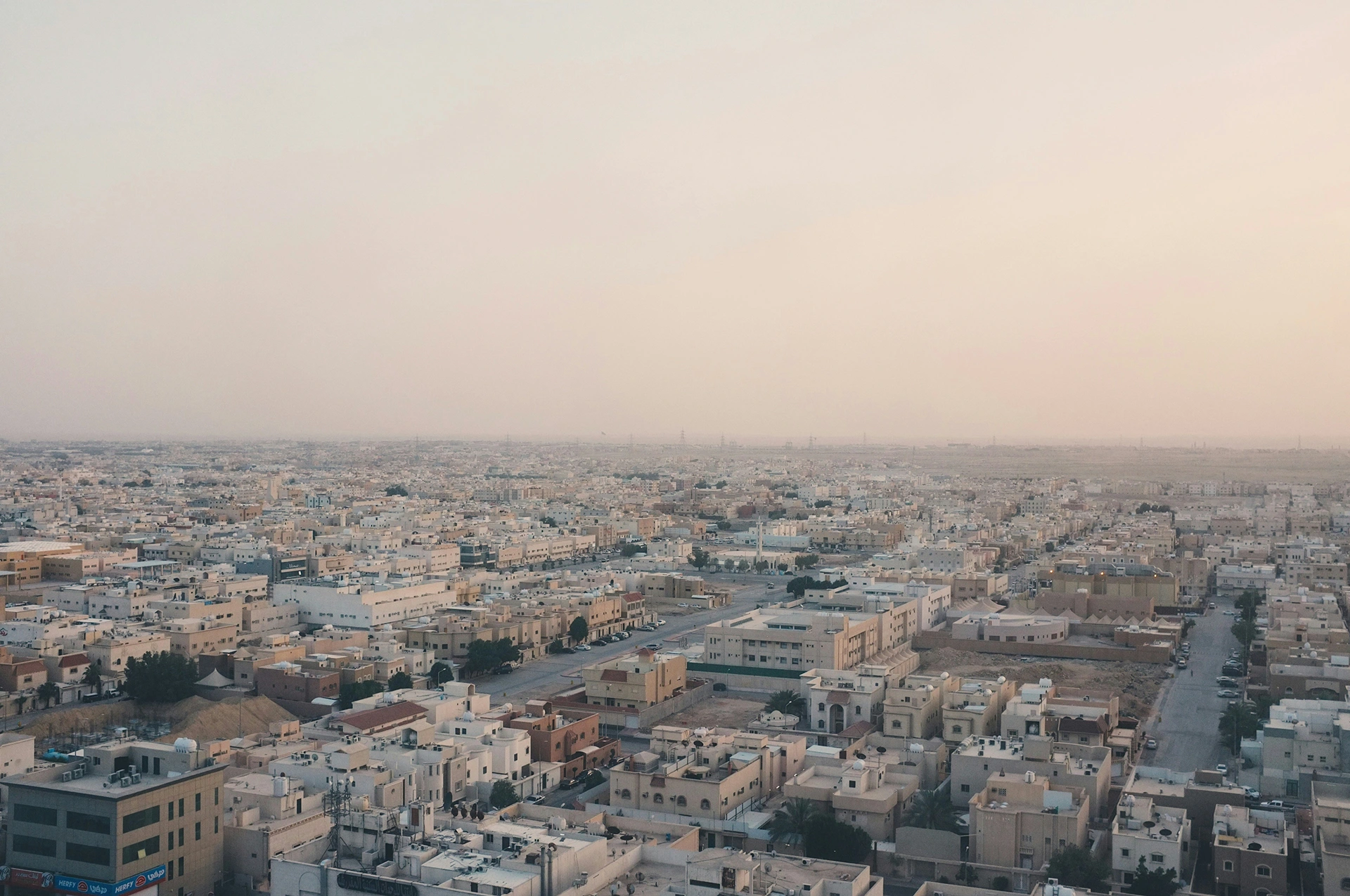An expansive view over the cityscape of Riyadh, Saudi Arabia under a hazy sky